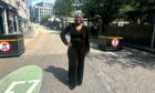 Anu Kasim wears a dark green velvet jumpsuit.