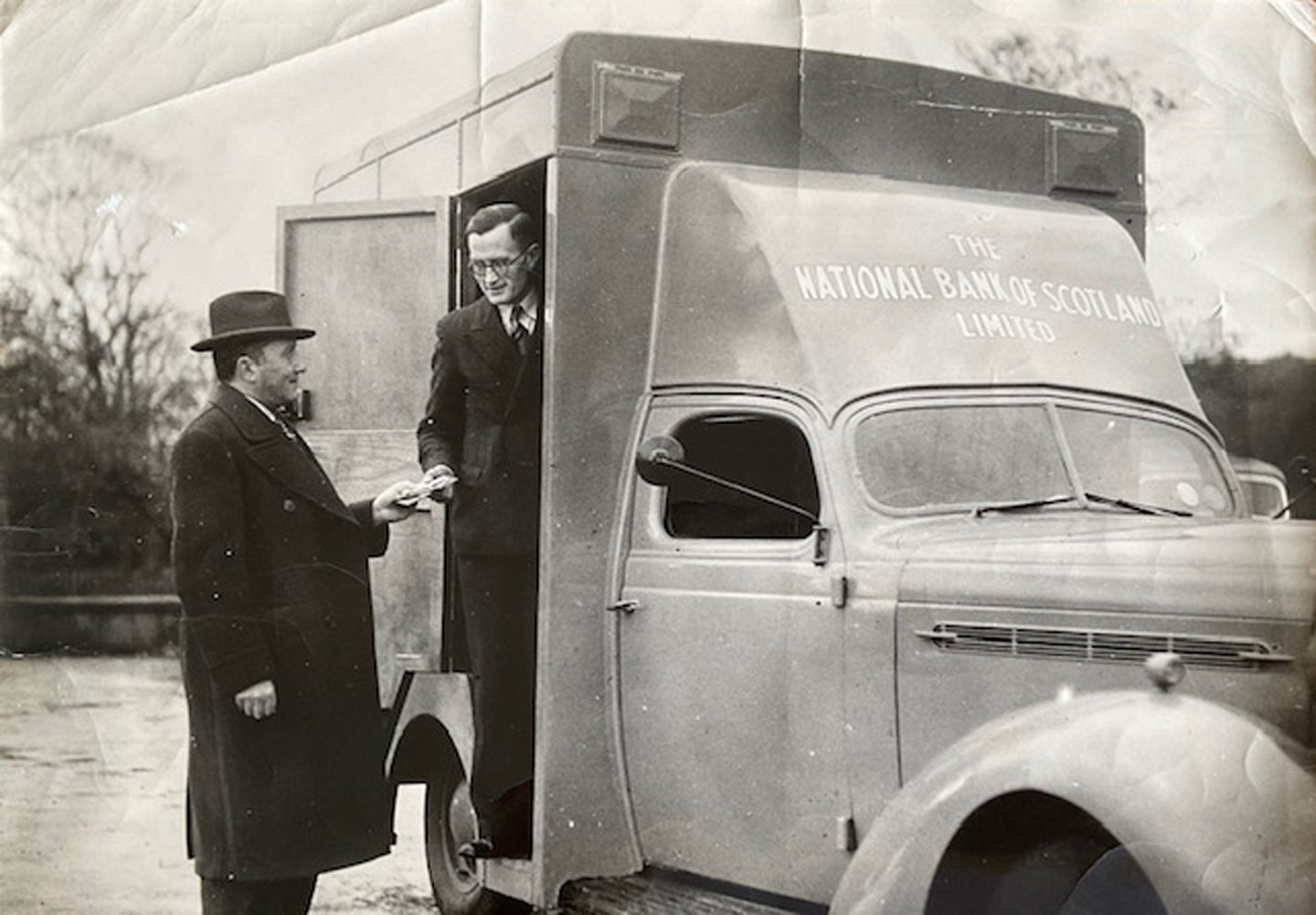 A customer and bank worker at the old van for the National Bank of Scotland.