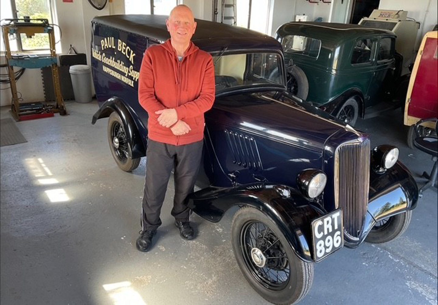 Ruaridh standing in front of a restored Paul Beck vintage car.