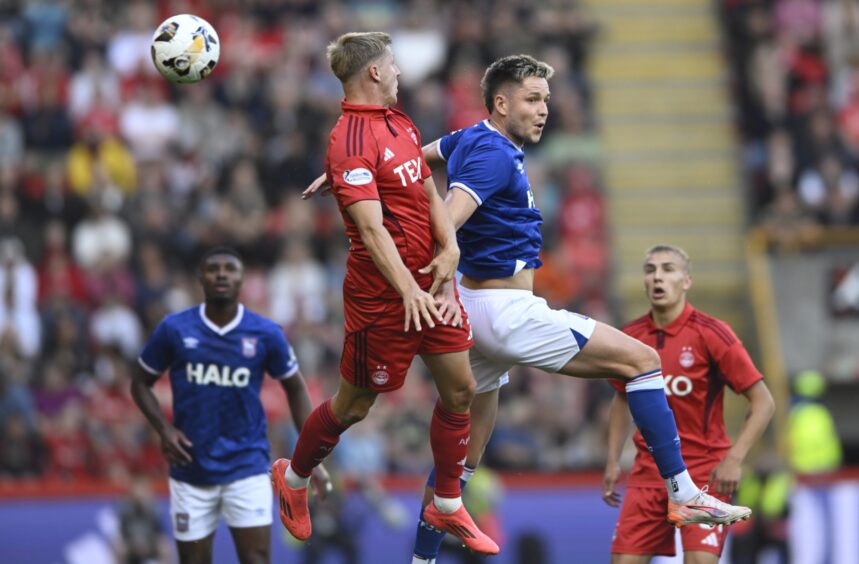 Mats Knoester of Aberdeen and scorer George Hirst of Ipswich Town. Image: Shutterstock.