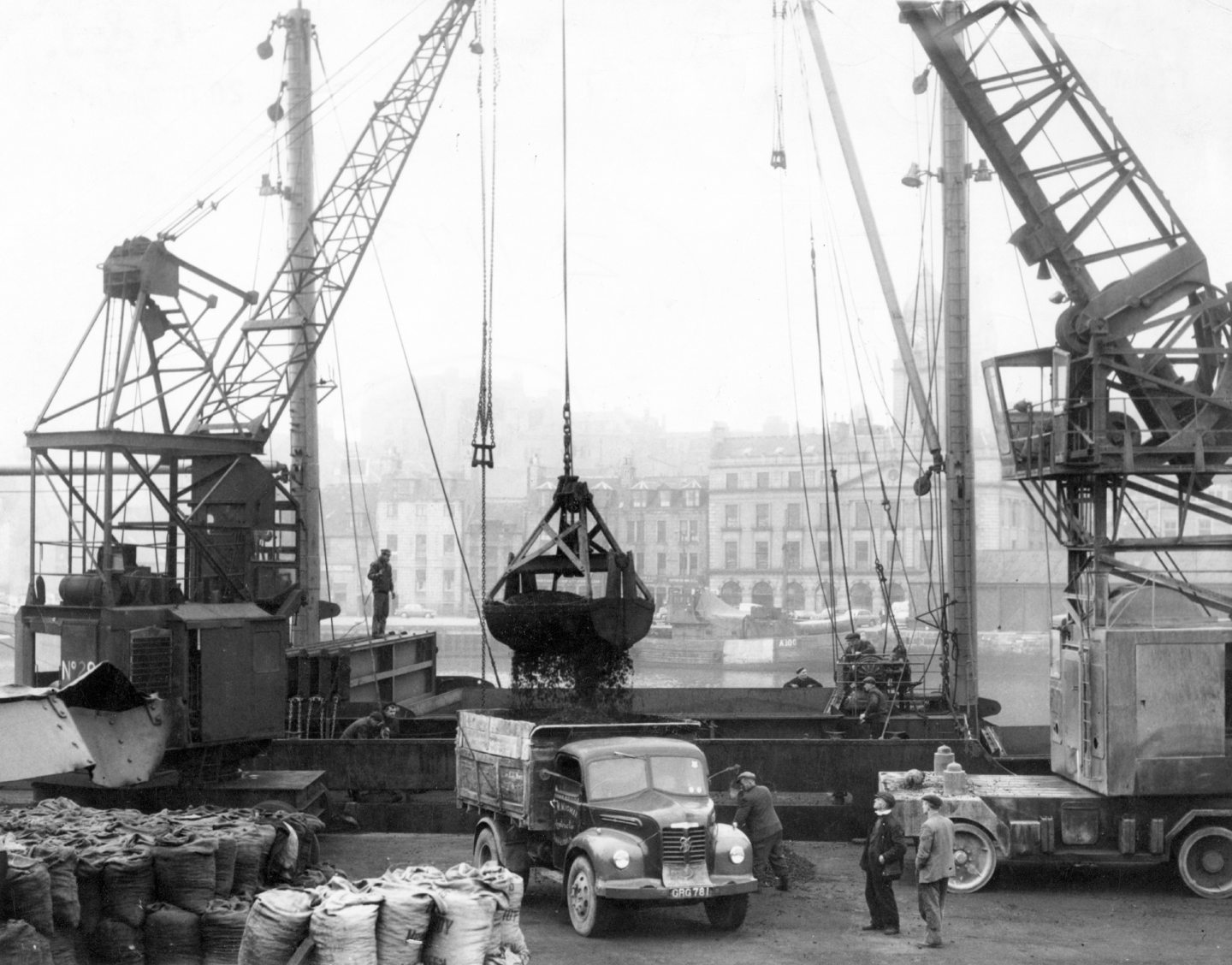 Cranes loading coal onto a lorry 