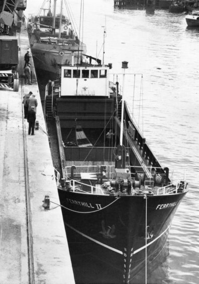 Ferryhill II, Aberdeen Coal and Shipping Company's new collier seen discharging her maiden cargo at Pacific Wharf. 