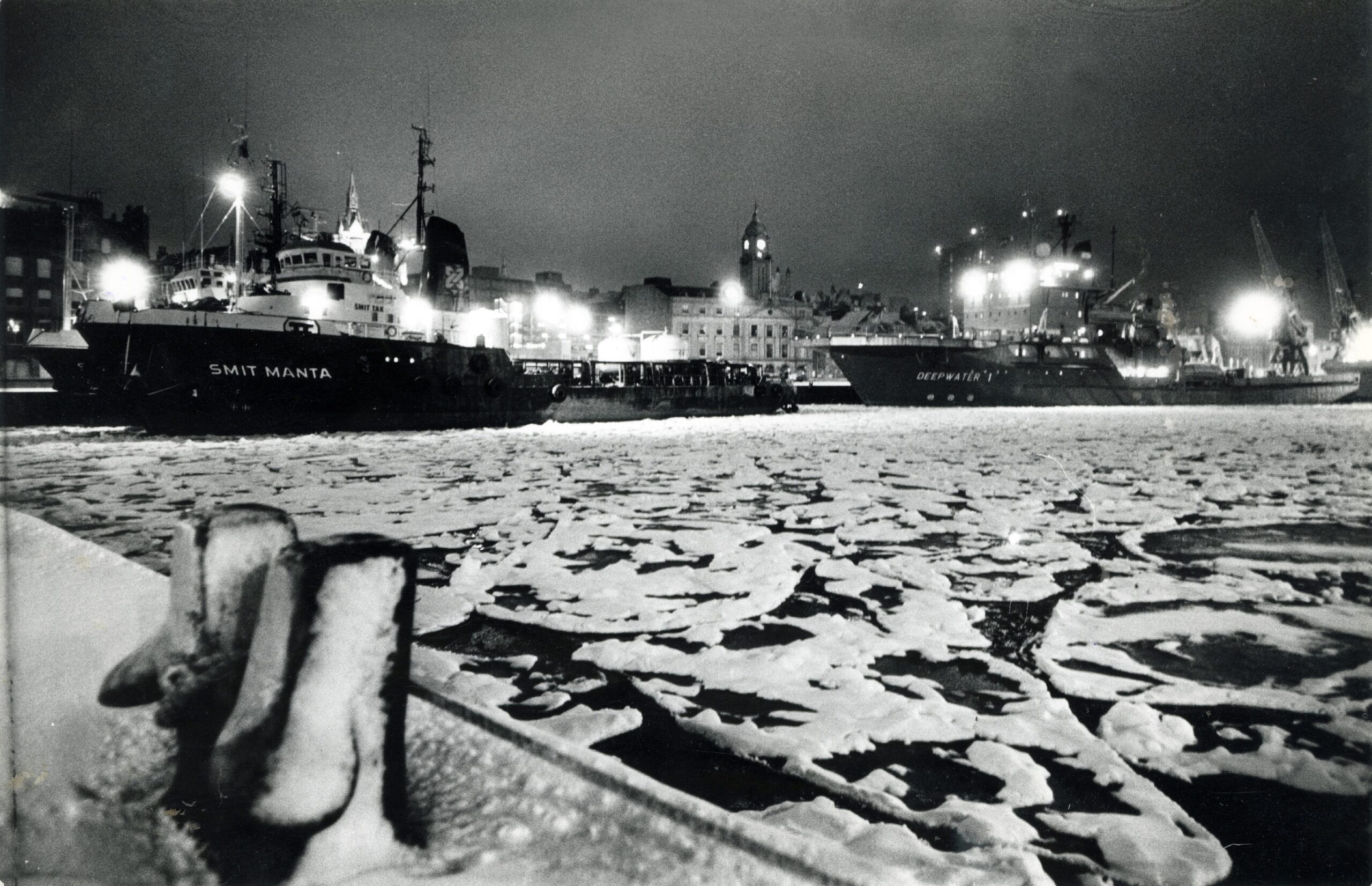 Ice floes and harbour lights sparkle in the frosty light of the wintry scene at Aberdeen Harbour's Upper Dock.