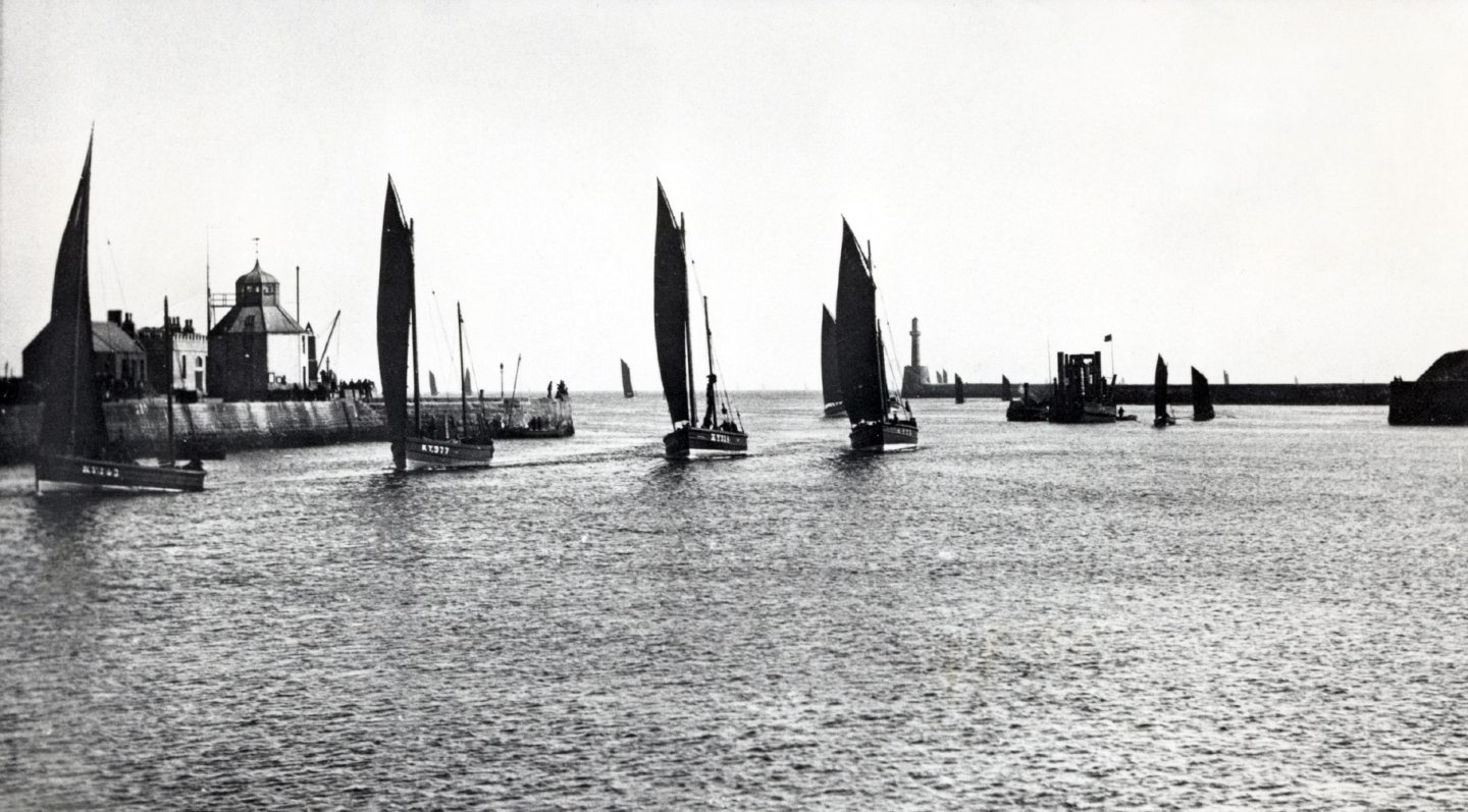 A line of Kirkcaldy-registered herring drifters entering the harbour around 1910 to land their catches at the fishmarket