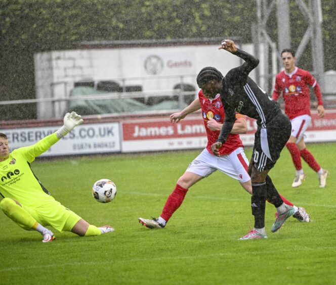 Cove Rangers striker David Eguaibor shoots past the Brechin City goalkeeper during a League Cup match.