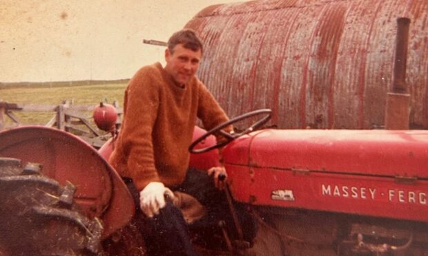 Orkney farmer Charlie Gorn on his Massey Ferguson tractor.