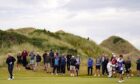 Crowds watch Colin Montgomerie hit.