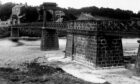 1938: The Shakkin' Briggie was a much-used route when this photo was taken in 1938, but floodwaters and the meandering Dee took their toll on the structure. Image: DC Thomson