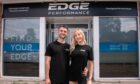 Aaron Cox and Victoria Hughes standing outside their new gym Edge Performance.