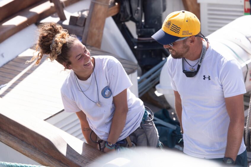 Two Pascual Flores crew members sharing a laugh on deck as the tall ship arrives at Aberdeen for the Tall Ships festival.