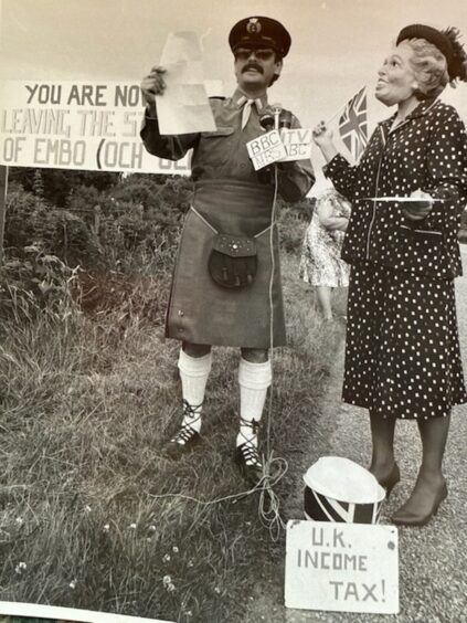 Two people dressed as a 'border guard' and 'Margaret Thatcher'.