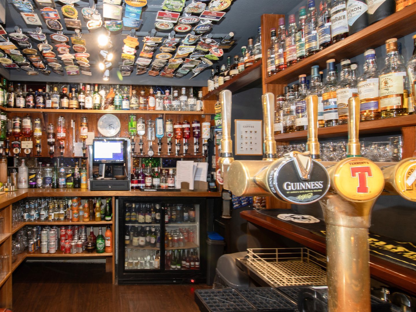 Beer mats adorn the ceiling of the bar.