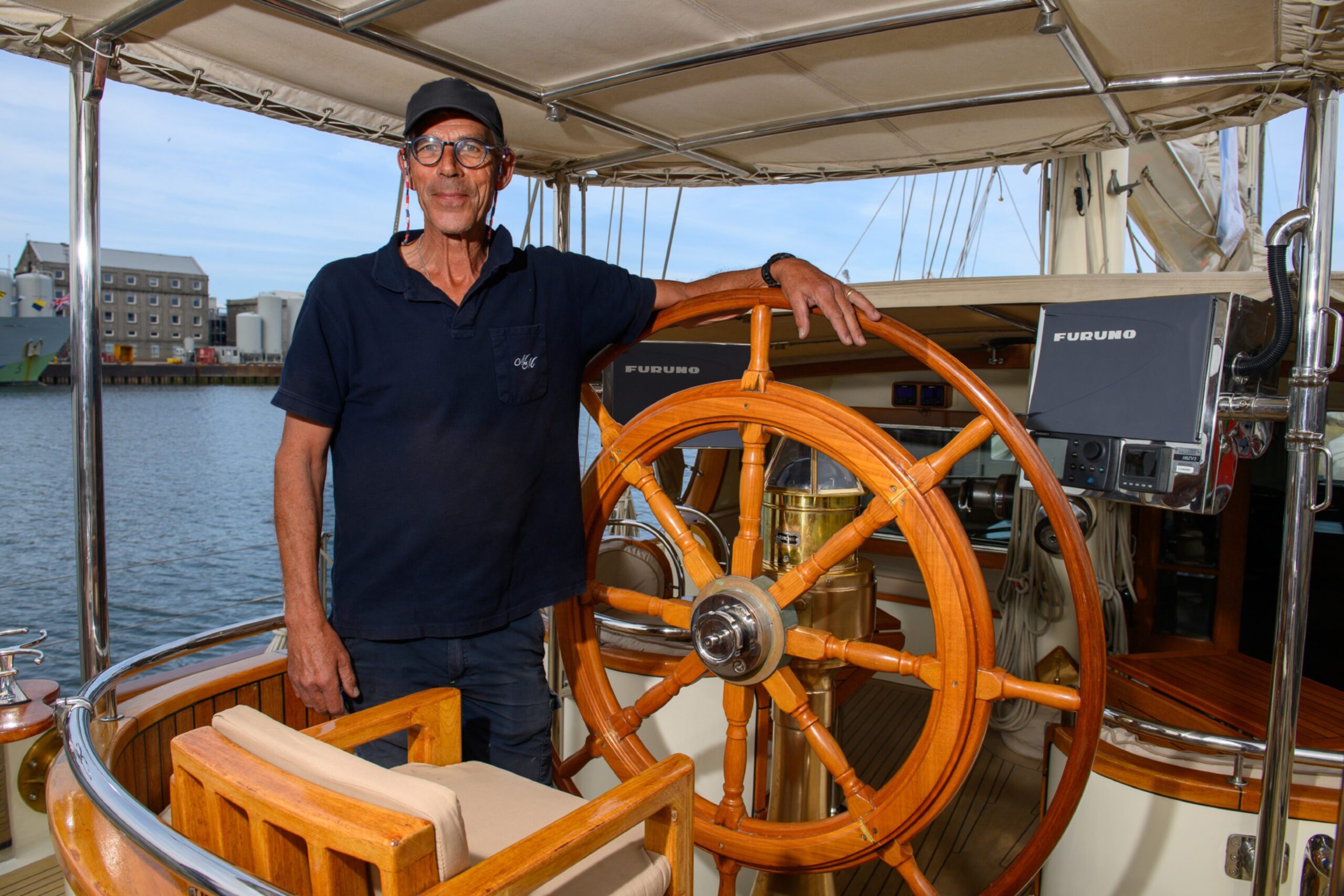 Goran Svalling, captain of the Malcolm Miller, stands by the wheel of the ship.