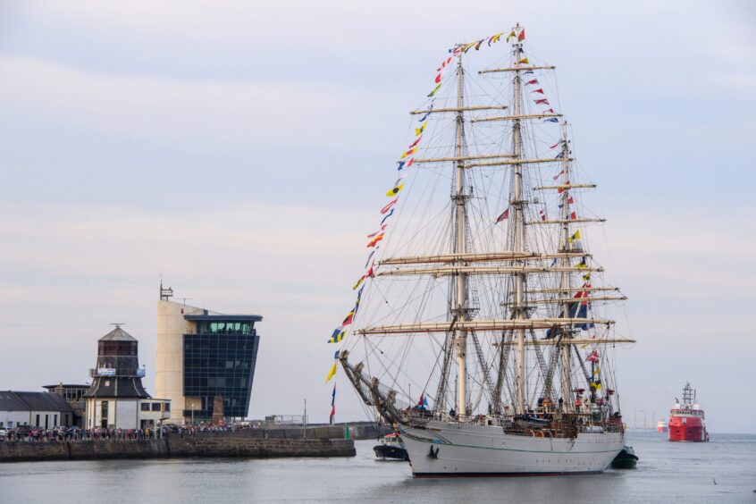 The Shabab Oman II pictured arriving into Aberdeen harbour, in front of a crowd of people.