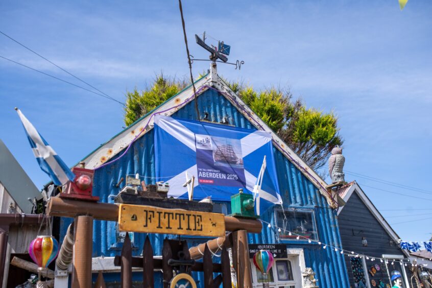 A saltire flag adorns a beach property in the Footdee area of Aberdeen harbour.