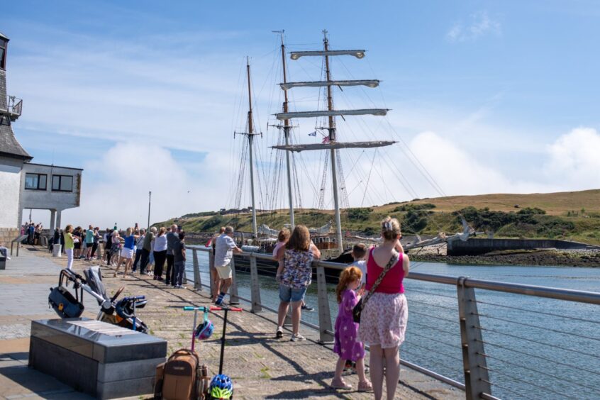 Crowds gather along Aberdeen harbour as boats arrive for the Tall Ships Races.