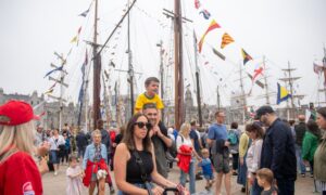 Family walking through Tall Ships site