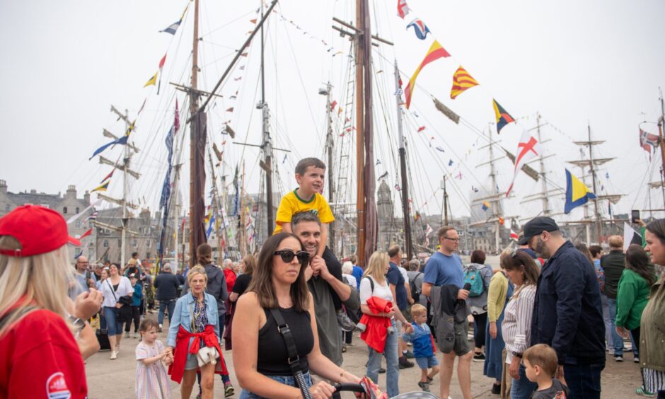 Family walking through Tall Ships site