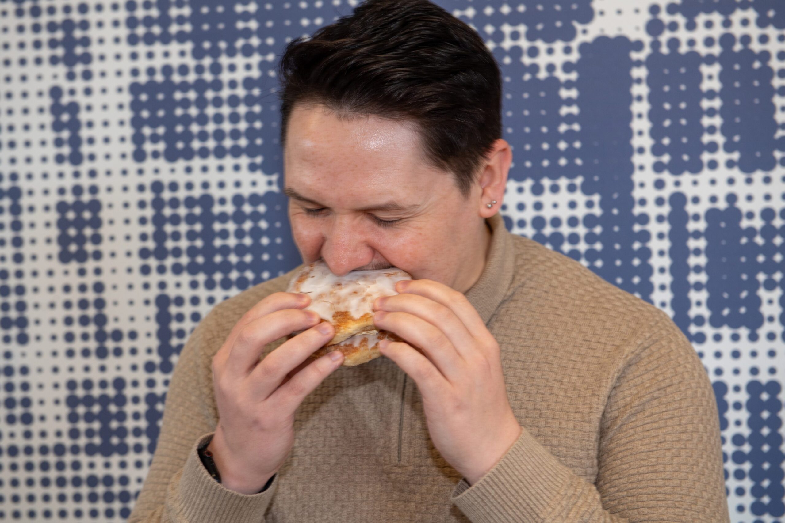 P&J reporter Ross taking a bite from one of The Bread Guy's sweet butteries