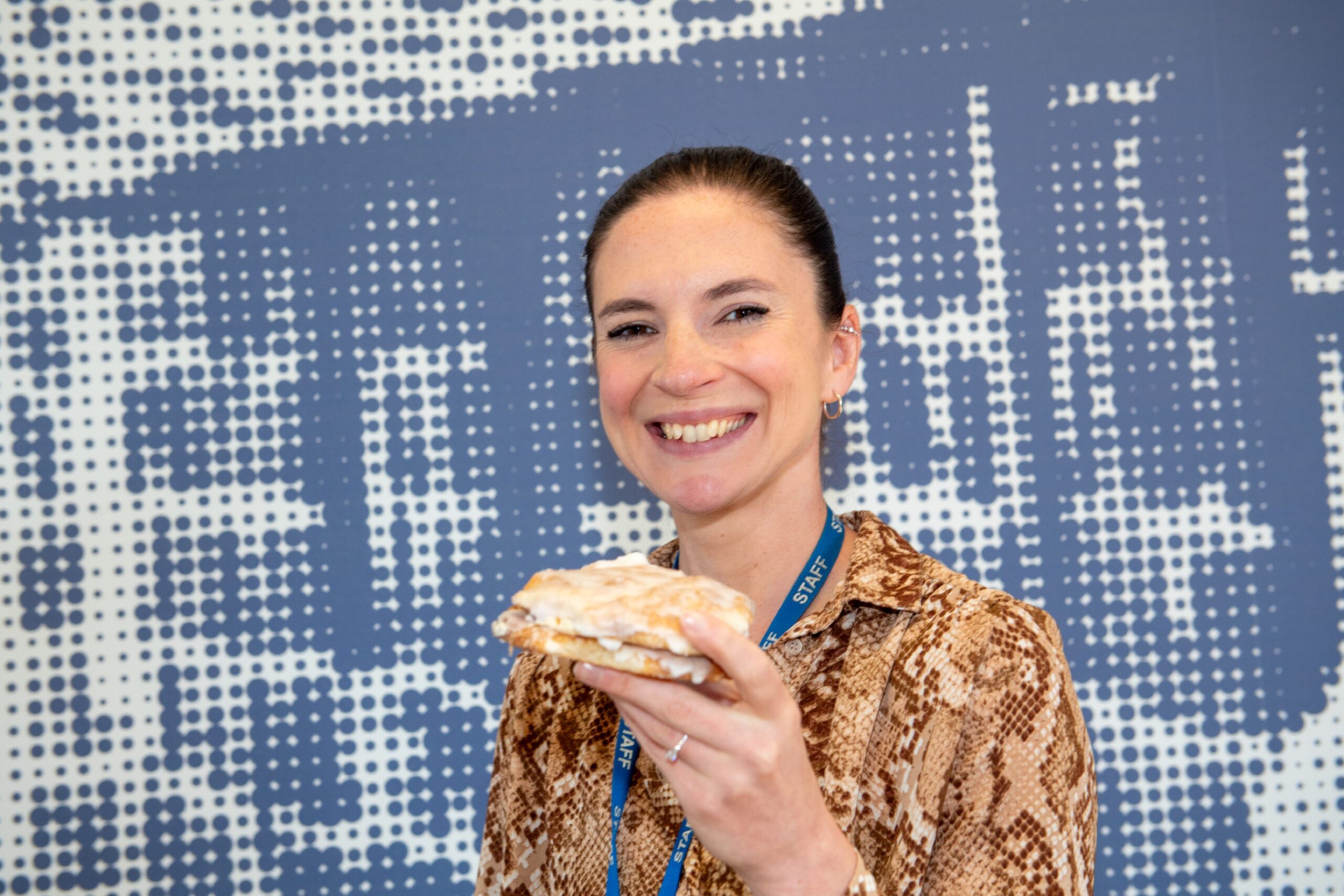 P&J feature writer Rosie smiling and holding a sweet-filled buttery from the bread guy.
