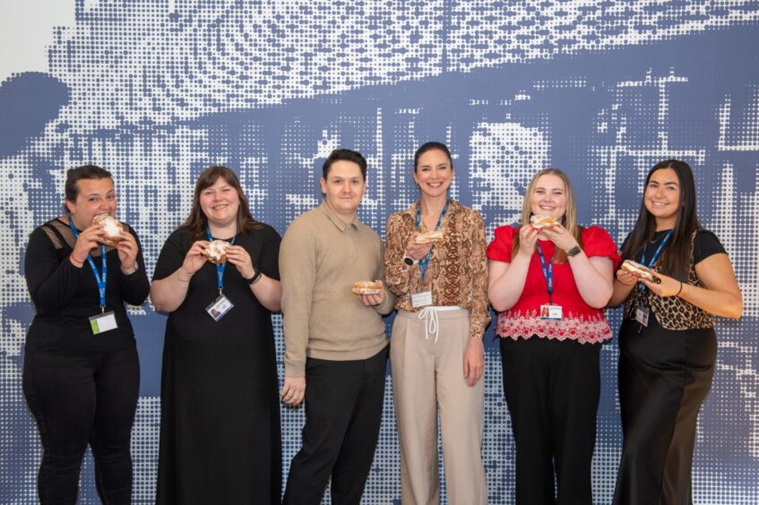 P&J staff standing in a line with butteries in their hands