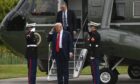 President Donald Trump takes the salute as he arrives in Aberdeenshire.