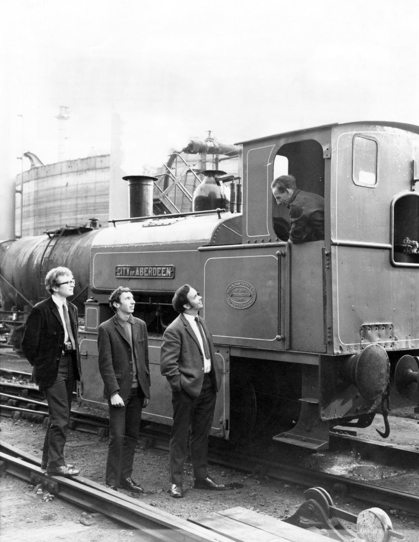 Mr Grove, Mr Johnston and Mr Horne, chat with the driver of the train, John Flett.