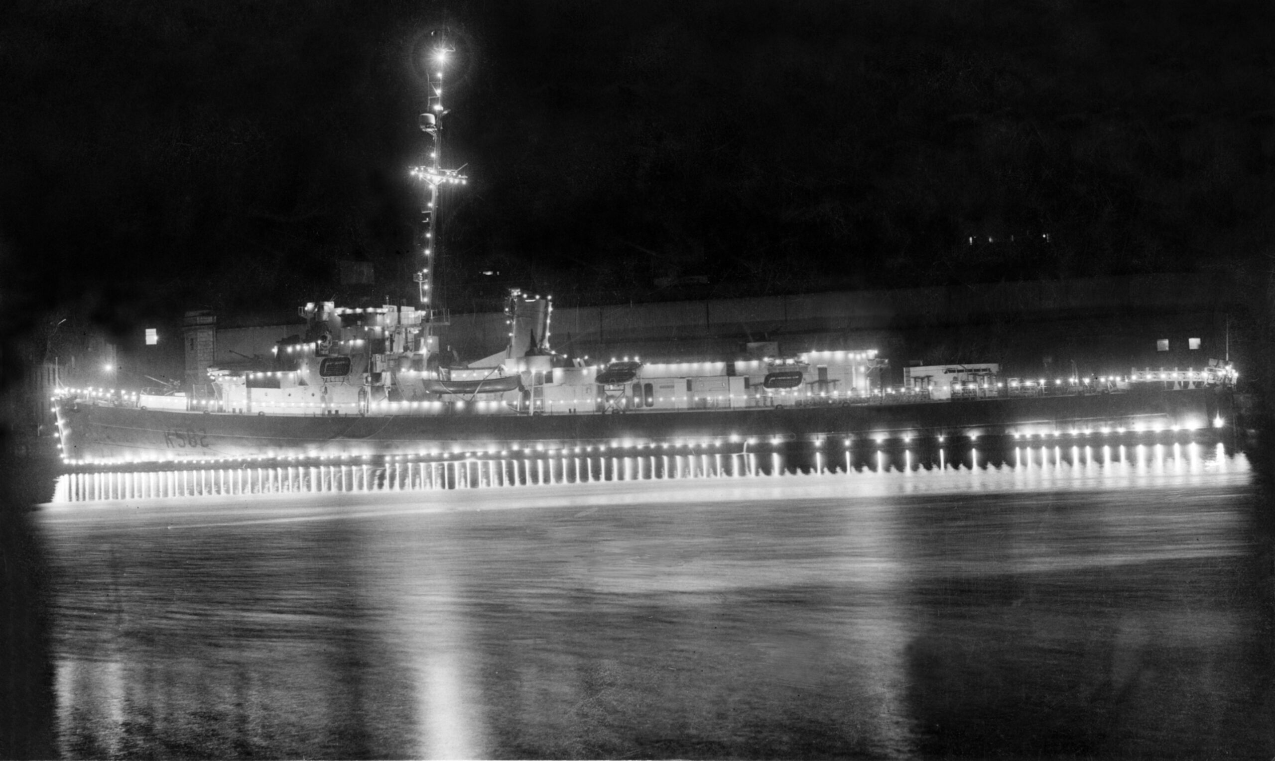 The frigate HMS Hargood all lit up in Aberdeen Harbour for an important moment in history - the end of World War II.