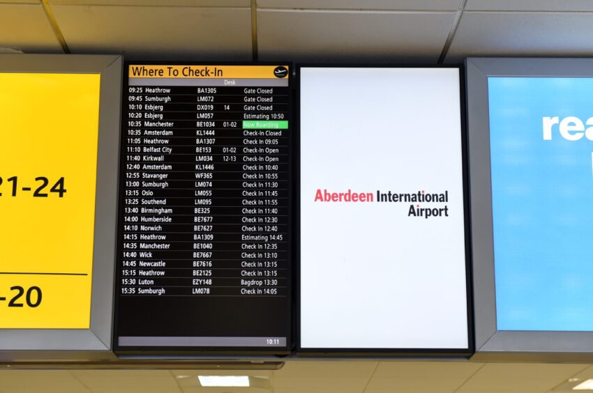 Aberdeen International Airport flight information board.