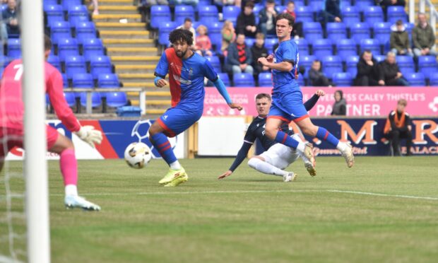Ronan Hale guide the ball into the net to give Ross County the lead at Inverness.  Image: Sandy McCook/DC Thomson