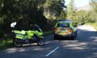 A police car and motorbike on the A832.