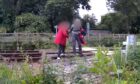 Man and woman trespass over the railway line in Dingwall.