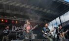 Aberdeen band Deadfire performing live at an outdoor festival.