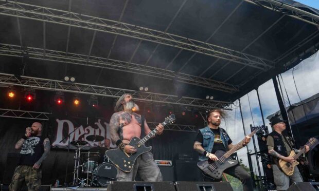 Aberdeen band Deadfire performing live at an outdoor festival.