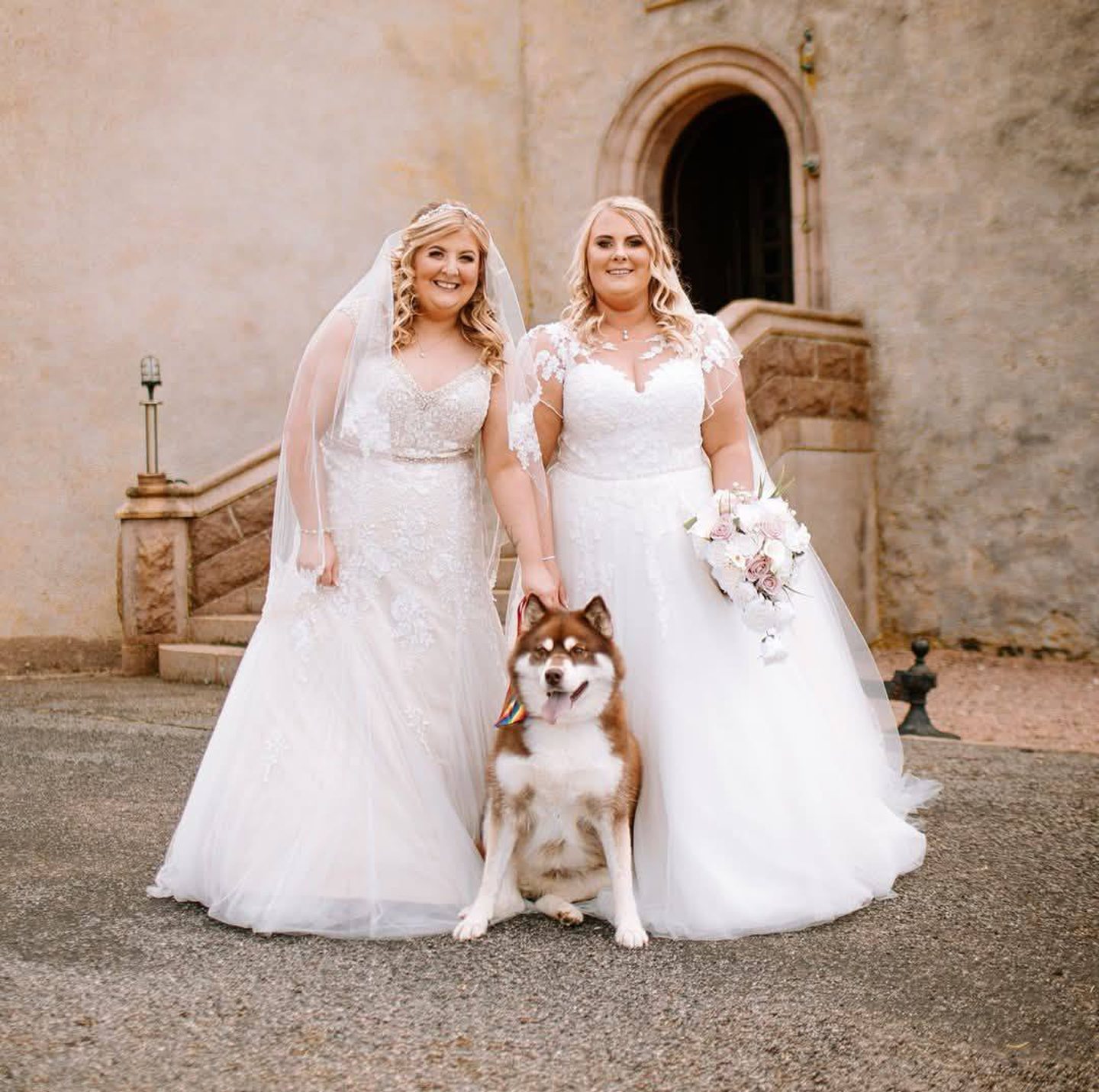 Debielee and Michelle McKenzie on their wedding day with their pet husky
