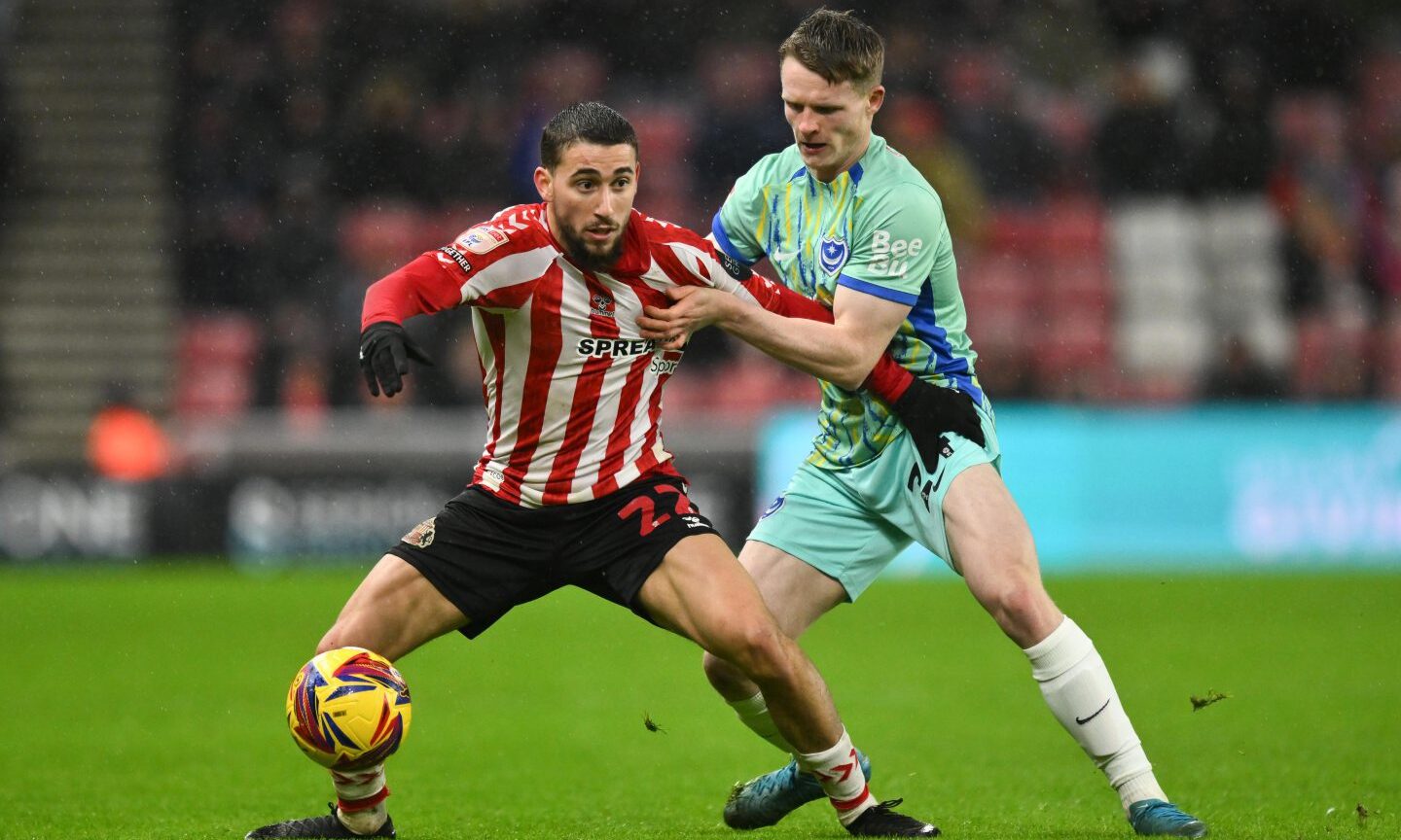 Adil Aouchiche of Sunderland (left) fends off Terry Devlin of Portsmouth in a Championship match.