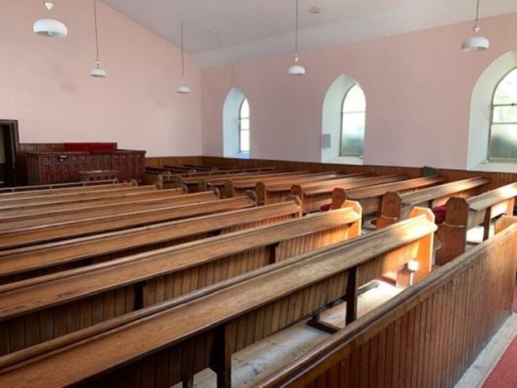 Rows of pews in the church as it was before it was converted into homes.