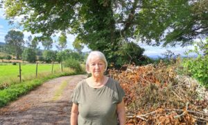 Carole Jamieson next to the dying tree