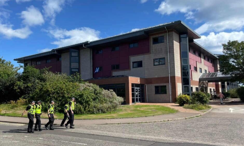 Police ahead of a protest at Aberdeen's former Patio hotel.