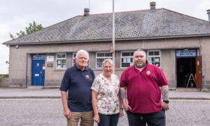 Members of the Oldmachar branch of the British Legion stand outside the social club.