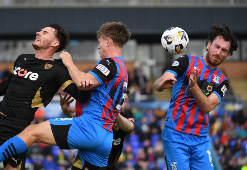 Peterhead's Kieran Shanks, left, is challenged by Inverness Caledonian Thistle's Oscar MacIntyre, centre, and Joe Chalmers during the SPFL Championship match at the Caledonian Stadium, Inverness, on August 9, 2025. 