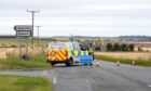 A police vehicle and road closed sign.