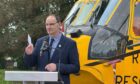 Morayvia chairman, Mark Mair, with the Sea King helicopter