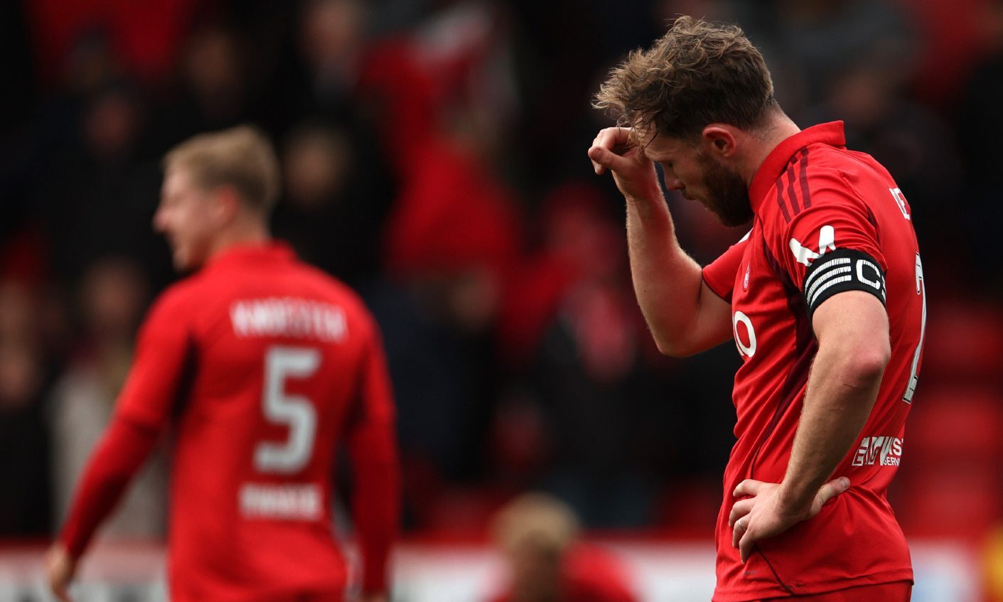 Aberdeen's Nicky Devlin looks dejected at the end of the Premier Sports Cup loss to Motherwell. Image: Shutterstock
