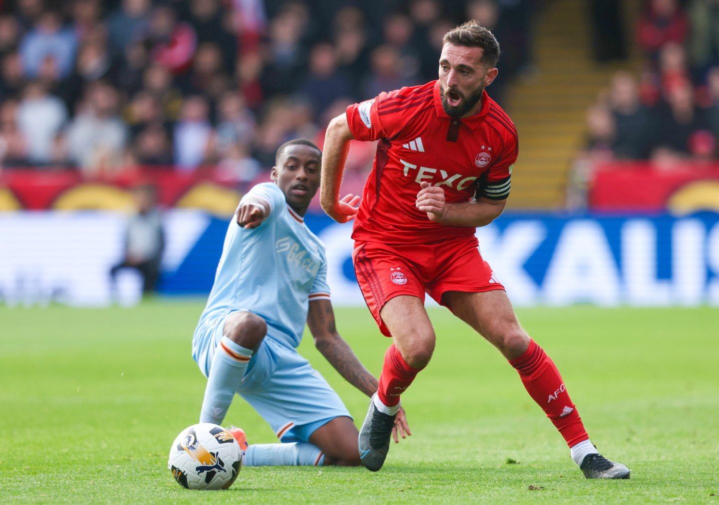 Aberdeen's Graeme Shinnie and Motherwell's Tawande Maswanhise battle for the ball in the Premier Sports Cup quarter-final. 