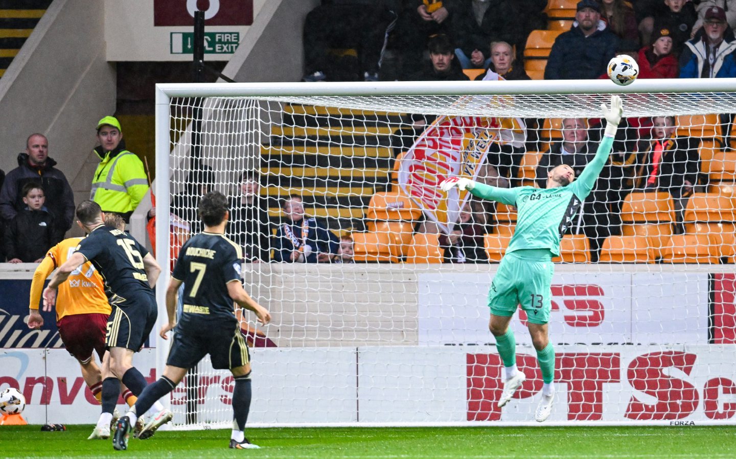 Aberdeen's Kevin Nisbet (L) has a headed shot but it's saved by Motherwell's Calum Ward. 