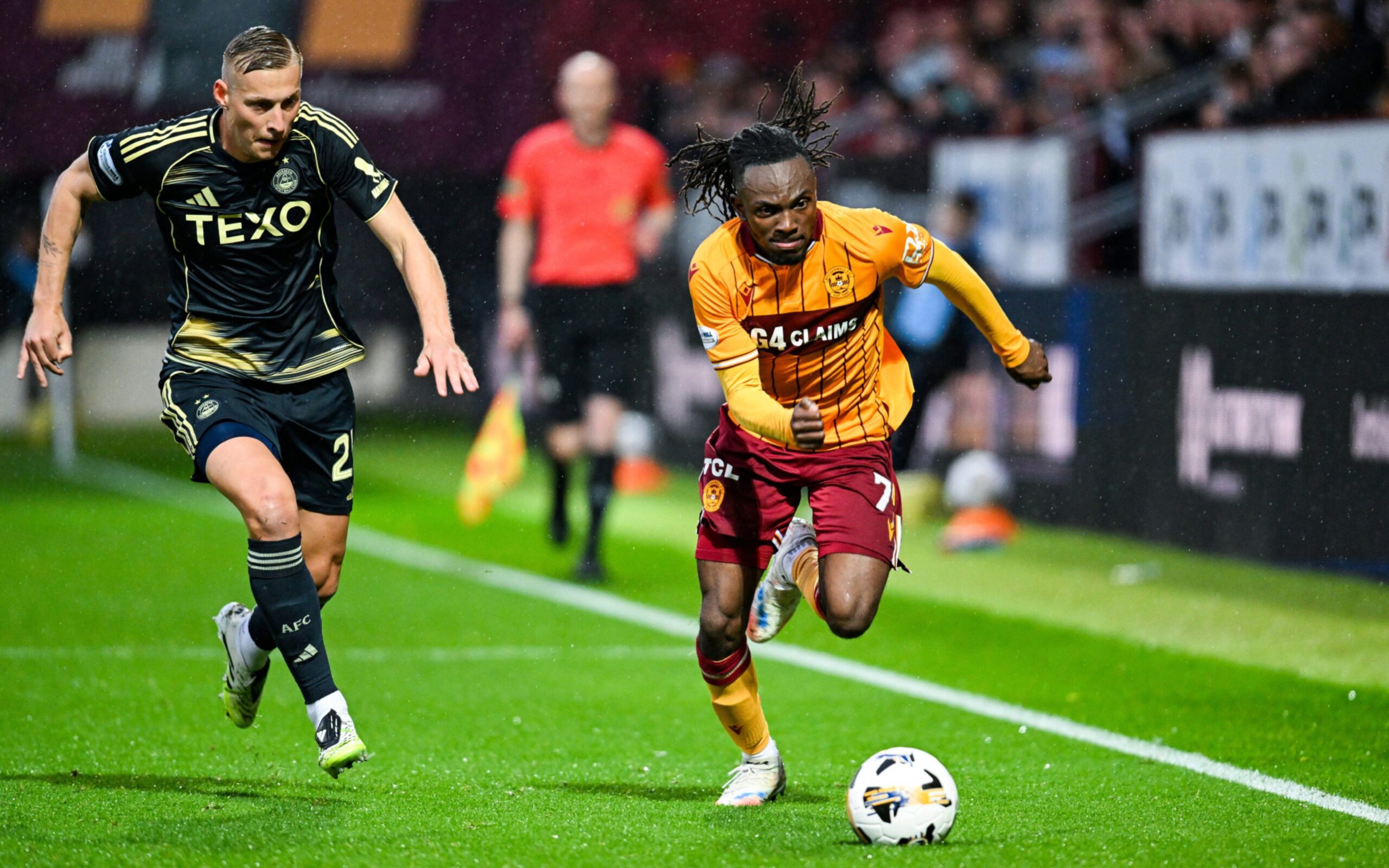Motherwell's Regan Charles-Cook (R) and Aberdeen's Kristers Tobers in action. 