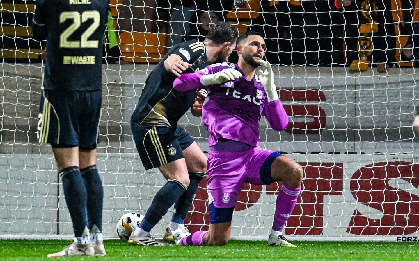 Aberdeen's Dimitar Mitov looks dejected as John Koutroumbis scores to make it 1-0 . 