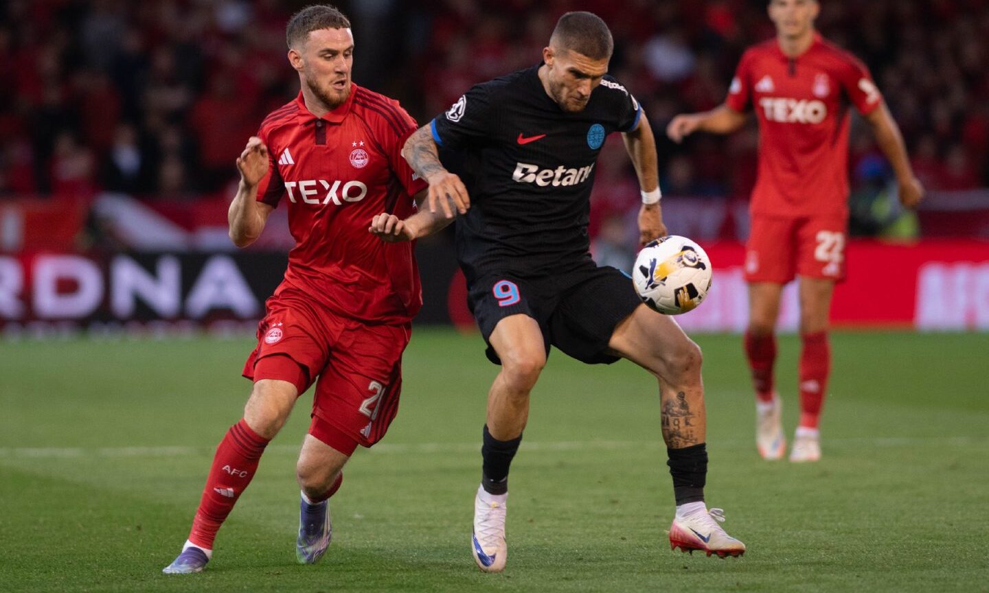 Aberdeen's Alfie Dorrington challenging FCSB's Daniel Birligea in the first leg of the sides' Europa League play-off tie, at Pittodrie. Image: Darrell Benns/DC Thomson.