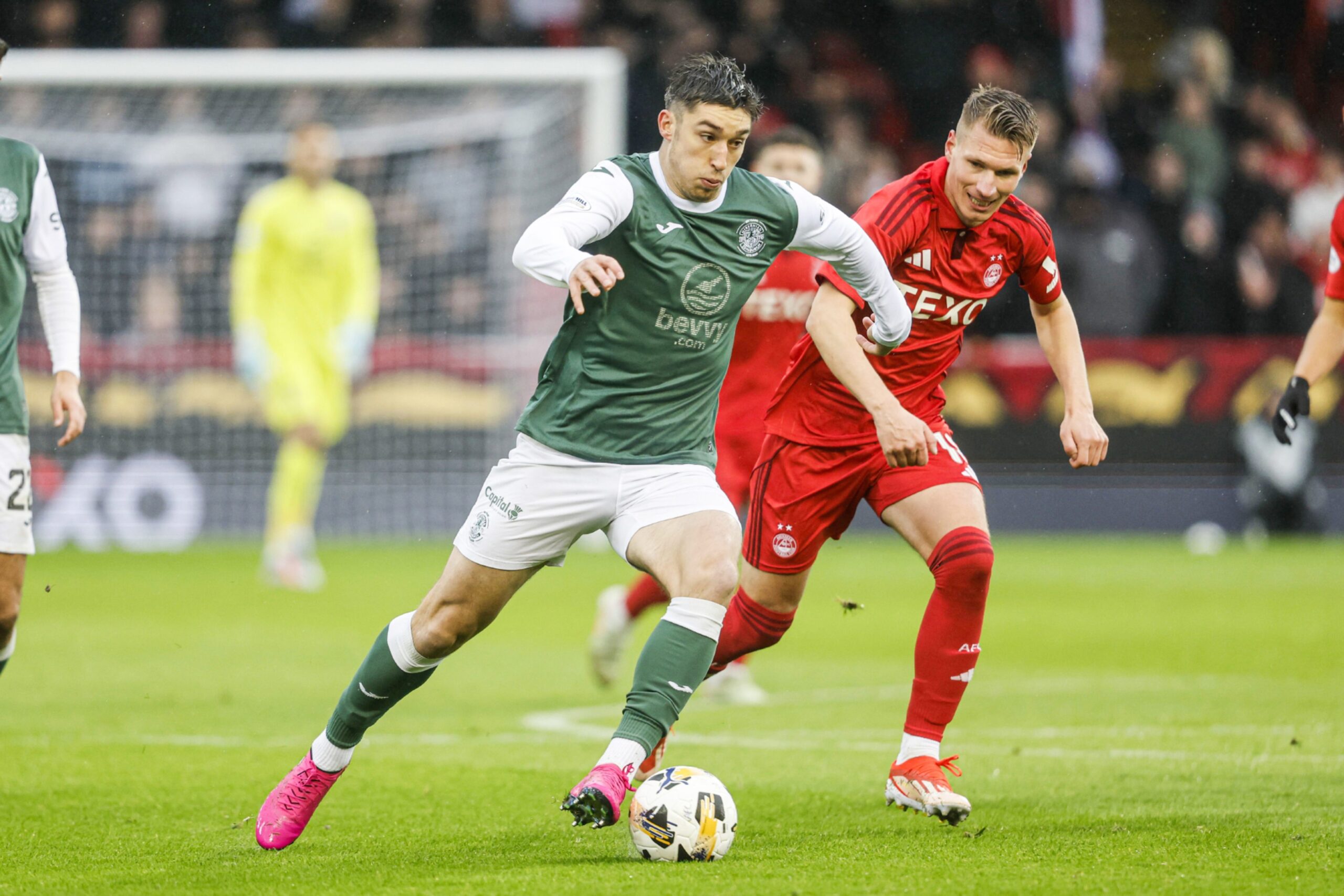Hibernian's Kieron Bowie in action against Aberdeen's Nicky Devlin in a Premiership match at Pittodrie.
